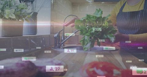 Home cook washing fresh herbs over sink with social media live stream interface and engagement icons