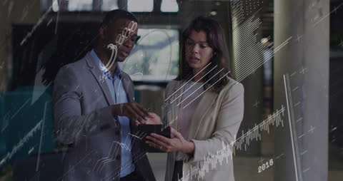 Diverse Business Professionals Analyzing Digital Financial Charts At Office