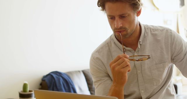 Young Professional Male Working Thoughtfully on Laptop - Download Free Stock Images Pikwizard.com