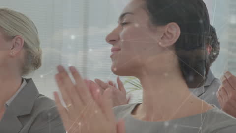 Business Professionals Applauding in Modern Office with Digital Overlay