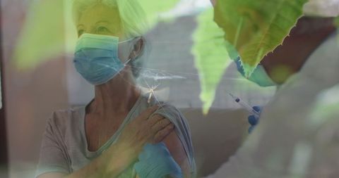 Senior Woman Receiving Vaccine with Focus on Malaria Awareness