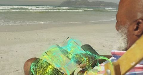 Senior Man Connecting with Literature via Hologram Book on Remote Beach