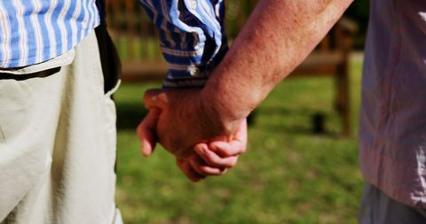 Elderly Couple Holding Hands Promoting Love and Support Outdoors