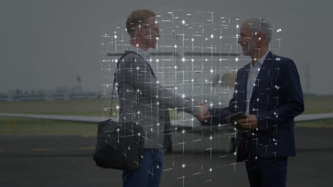 Digital Network Connections with Businessmen Shaking Hands