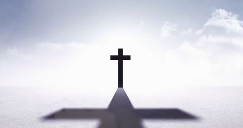 Silhouette of Cross with Long Shadow on Cloudy Horizon - Download Free Stock Images Pikwizard.com