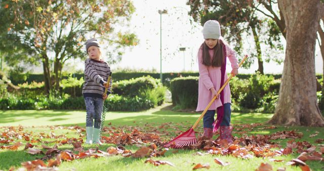 Children Raking Autumn Leaves in Park During Fall Season - Download Free Stock Images Pikwizard.com