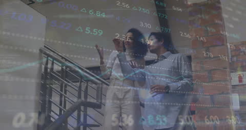 Diverse Colleagues Discussing Stock Market Trends in Office