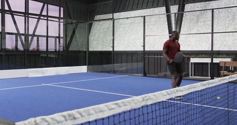 Athlete Practicing on Padel Court in Modern Indoor Facility