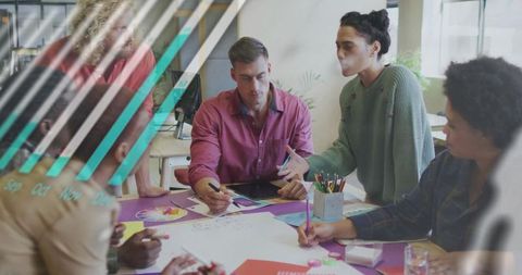 Team Collaborating in Creative Office with Charts and Colorful Supplies