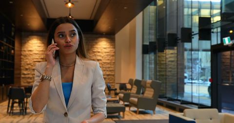 Confident Businesswoman Conversing on Mobile Phone in Modern Office