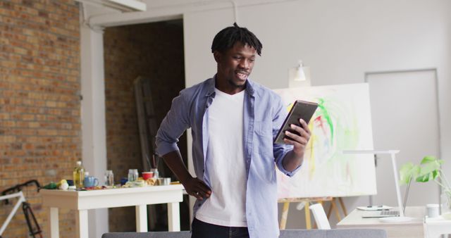 Artist Checking Tablet in Sunlit Studio - Download Free Stock Images Pikwizard.com