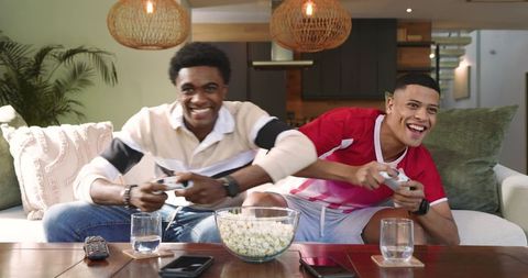 Diverse Friends Gaming Together on Cozy Living Room Couch