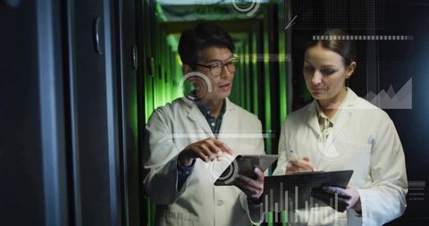 IT engineers in lab coats monitoring server racks with tablet, clipboard and analytics HUD