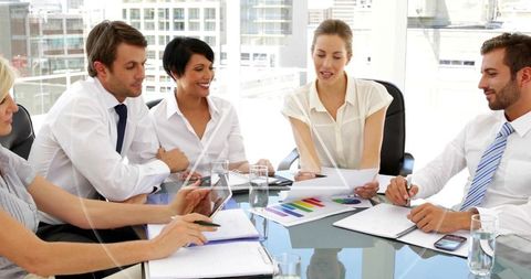 Business Team Reviewing Analytics Charts in Modern Office Setting