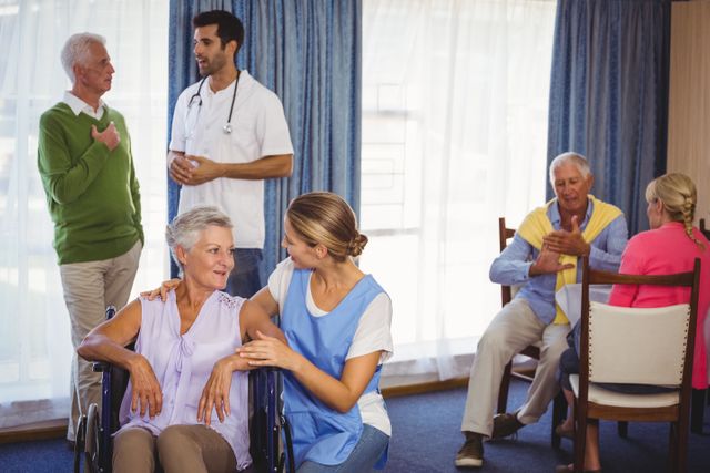 Nurses having discussions with seniors patients in retirement house