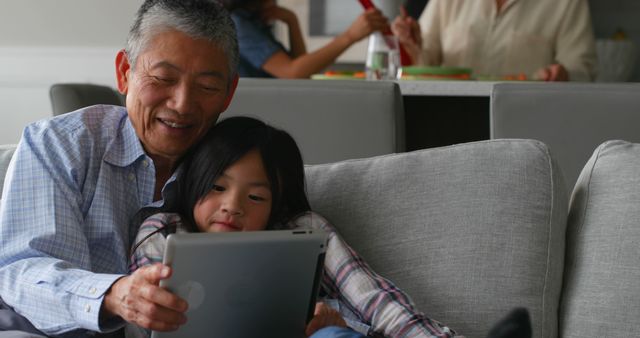 Grandfather and Granddaughter Using Tablet Together at Home - Download Free Stock Images Pikwizard.com