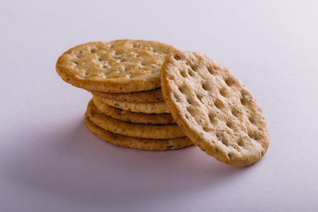 Close-up of stacked crackers over white background with copy space. unaltered, food, studio shot and snack.
