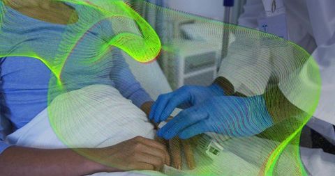 Clinician placing wrist sensor on patient in hospital bed for bedside vital signs monitoring