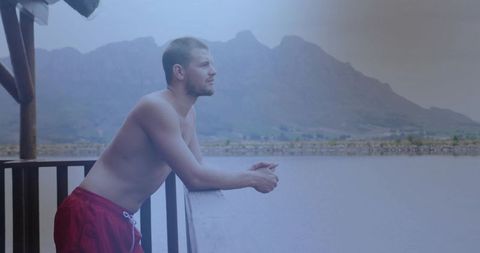 Serene Man Enjoying Mountain View by Tranquil Lake
