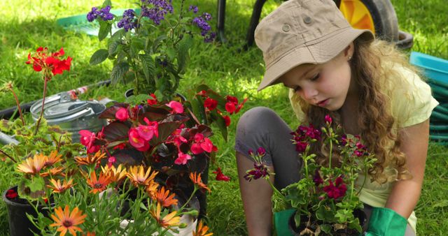 Young girl gardening with colorful flowers in sunny garden, ideal for promoting children's outdoor activities, nature exploration, gardening tutorials, educational materials, and environmental awareness campaigns. Suitable for spring and summer themes.