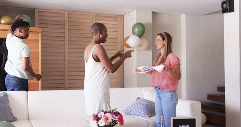Friends Decorating Living Room for Party Celebration