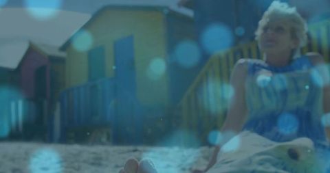 Mature Woman Relaxing at Vibrant Coastal Beach Cabins