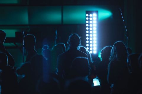 Silhouetted Crowd Enjoying Concert with Blue Lighting