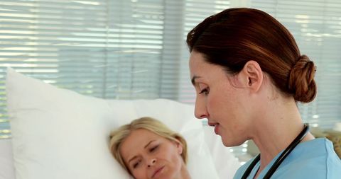 Nurse attending to patient in comfortable hospital room