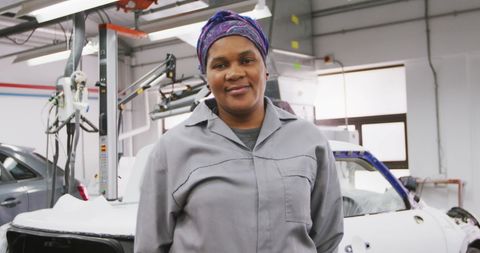 Female Automotive Mechanic Smiling Confidently in Workshop