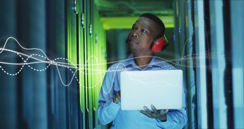 IT Engineer Analyzing Data in Server Room with Abstract Graphic Overlay - Download Free Stock Images Pikwizard.com