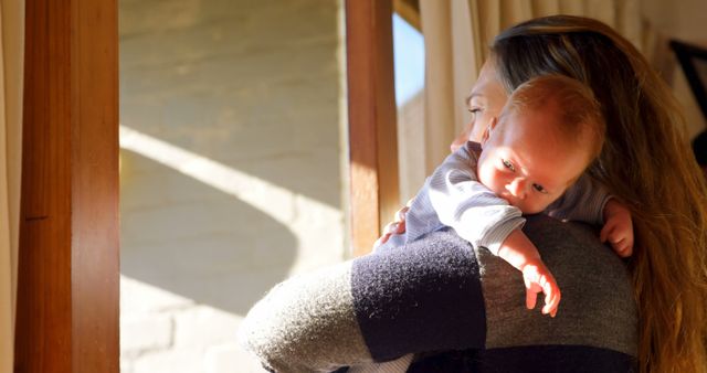 Mother Holding Newborn Baby Enjoying Morning Sunlight - Download Free Stock Images Pikwizard.com