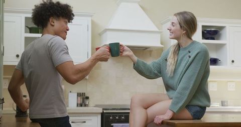 Happy Couple Enjoying Coffee and Quality Time in Kitchen