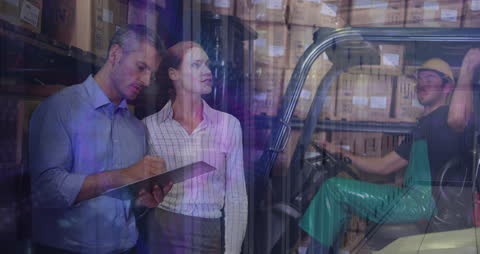 Warehouse Workers Collaborating in Modern Storage Facility