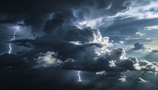Dramatic Cumulonimbus Thunderstorm with Lightning Strikes and Sunrays Piercing Clouds