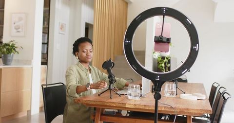 African American Woman Recording Podcast with Ring Light and Microphone at Home