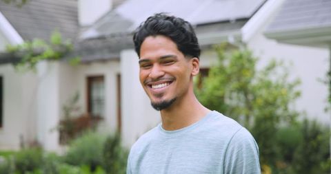 Smiling man in a sustainable suburban neighborhood