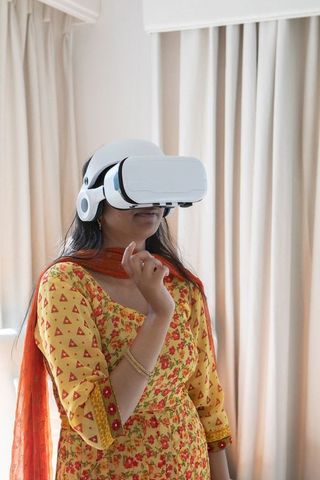 Indian Woman Exploring Virtual Reality at Home in Traditional Attire