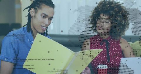 Young professionals collaborating over folder and laptop with digital analytics overlay