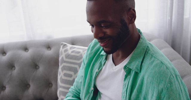 Smiling Man Sitting on Sofa at Home - Download Free Stock Images Pikwizard.com