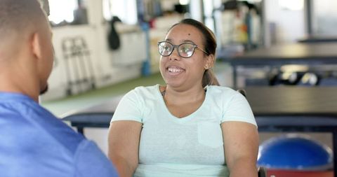 Paraplegic Woman in Wheeled Rehabilitation Session with Therapist