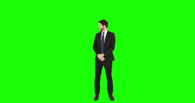 A Caucasian businessman stands confidently against a green screen background, with copy space. His professional attire and posture suggest a corporate or formal setting ready for customized graphics.