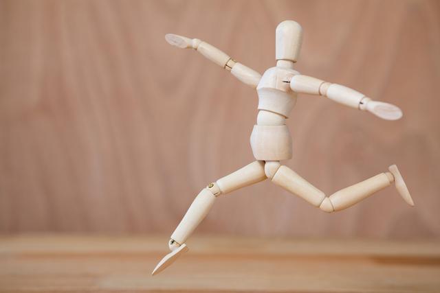 Conceptual image of figurine jogging on a wooden floor