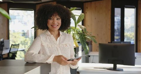 Confident Businesswoman Using Tablet in Modern Office Workspace