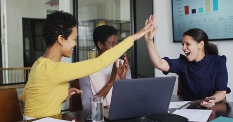 Diverse Businesswomen Celebrating Success with High Fives