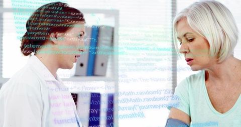 Doctor measuring senior patient blood pressure with digital health overlay for telemedicine