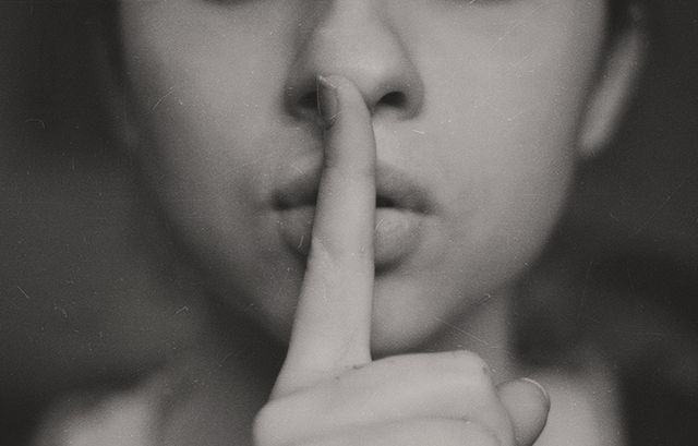 Close-Up Shot of Person Gesturing Silence With Finger on Lips - Download Free Stock Photos Pikwizard.com
