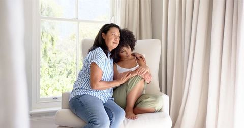 Mother Comforting Teenage Daughter at Home
