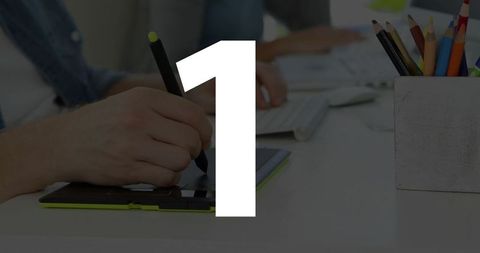 Designer using tablet and stylus with team collaboration