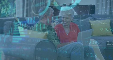 Senior couple analyzing financial data with laptop at home