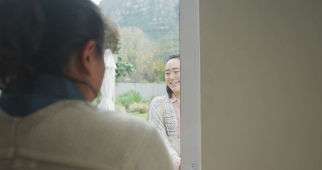 Smiling Woman Welcoming Visitor at Doorway - Download Free Stock Images Pikwizard.com